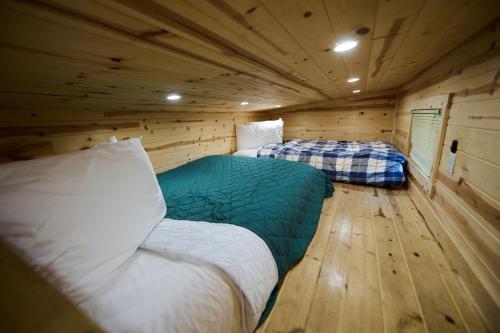 a room with two beds in a wooden cabin at Mount Hood Village in Welches
