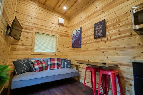 a log cabin with a couch and a table and stools at Mount Hood Village in Welches