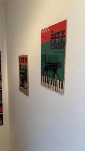 a book hanging on a wall with two pictures at Jazz Loft in Perugia