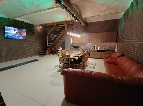 a kitchen and dining room with a table and chairs at Ernests' unique townhouse with sauna, hot tub and free parking in Rīga