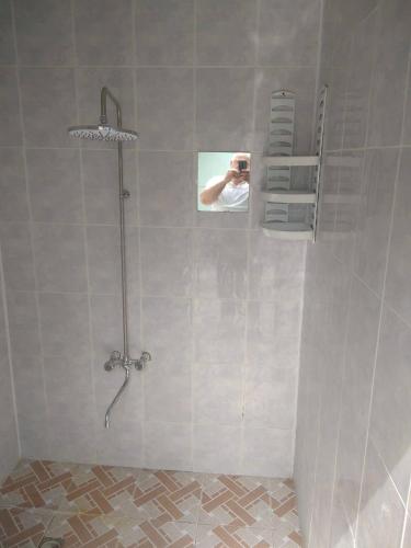 a person taking a picture of a shower in a bathroom at Shaki Best house in Sheki