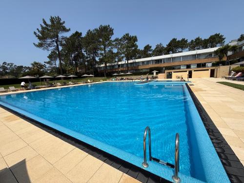 a large blue swimming pool in a building at 125 House - Swimming Pool, Tennis, Golf & Nature in Esposende