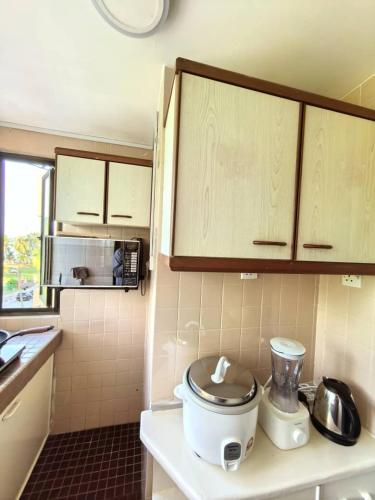 a small kitchen with a toilet on a counter at Condo by the Beach Port Dickson - Forest & Poolview in Port Dickson