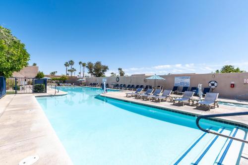 a swimming pool with lounge chairs in a resort at Vista Mirage Resort in Palm Springs