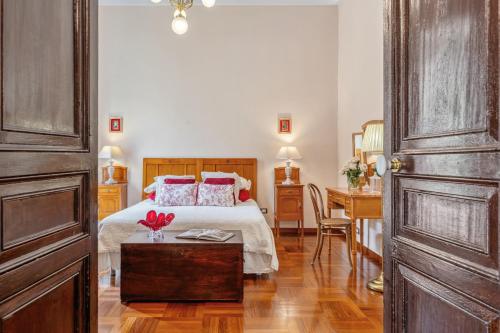 a bedroom with a bed and a desk and a table at Palazzo Di Lorenzo - Exclusive Palace with Panoramic Terrace and Minipool in Noto