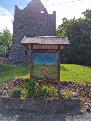 a painting of a cow in a field in a garden at Castle view Cabin 