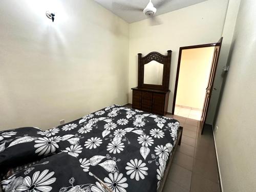 a bedroom with a bed with a black and white blanket at House of Sincerity in Maharagama