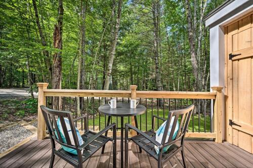 a patio with two chairs and a table on a deck at Modern Mtn Home*Pools*Fire Pit* in Campton