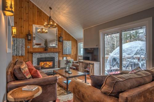 a living room with two couches and a fireplace at Modern Mtn Home*Pools*Fire Pit* in Campton