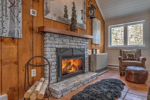 a living room with a fireplace in a house at Modern Mtn Home*Pools*Fire Pit* in Campton