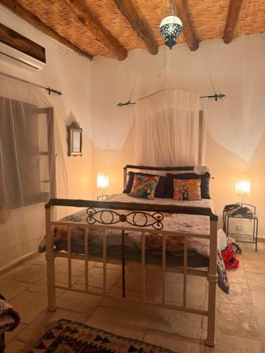 a bedroom with a bed in a room at A historic STONE VILLA with private garden, terrace and private pool just for you in Kliru