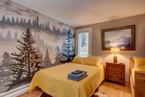 a bedroom with a bed with a painting on the wall at Modern Mtn Home*Pools*Fire Pit* in Campton