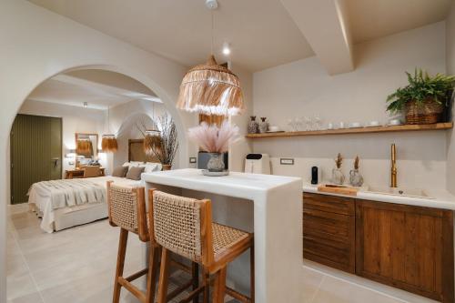 a kitchen and living room with a table and chairs at Chic Elysium Bliss in Naxos Chora