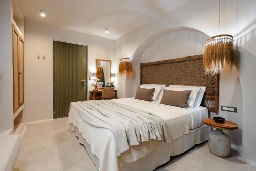 a bedroom with a large bed and a table at Chic Elysium Bliss in Naxos Chora