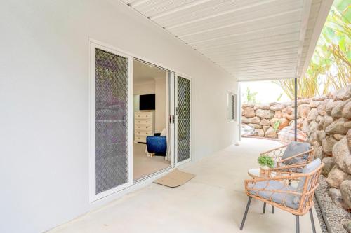 a living room with a stone wall at Palm Cove Studio Apartments in Palm Cove