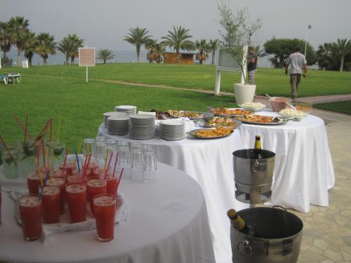 a table with plates of food and drinks on it at Polyxenia Isaak Luxury Villas and Apartments in Protaras