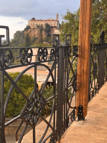 a black iron bridge with a view of a castle at A historic STONE VILLA with private garden, terrace and private pool just for you in Kliru