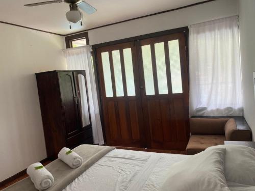 a bedroom with a bed and a sliding door at Villas manuel antonio in Quepos
