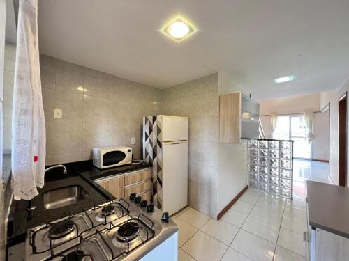 a kitchen with a stove and a refrigerator at Recanto da montanha in Teresópolis
