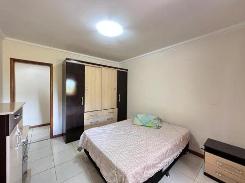 a bedroom with a bed and a dresser in it at Recanto da montanha in Teresópolis