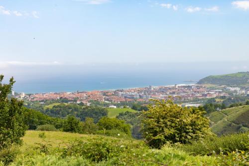 a view of a city from a hill at Izetaerdi - Casa con encanto y vistas únicas in Zarautz