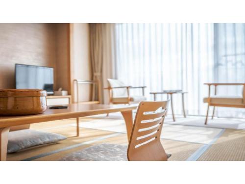 a living room with a table and a chair at Ouka no sato La-Foret Shobara - Vacation STAY 35116v in Shōbara