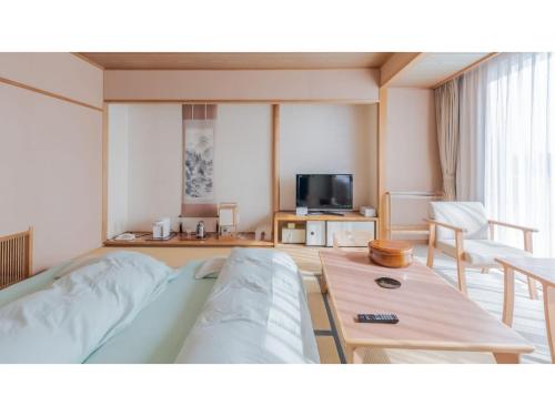 a living room with a bed and a tv at Ouka no sato La-Foret Shobara - Vacation STAY 35116v in Shōbara