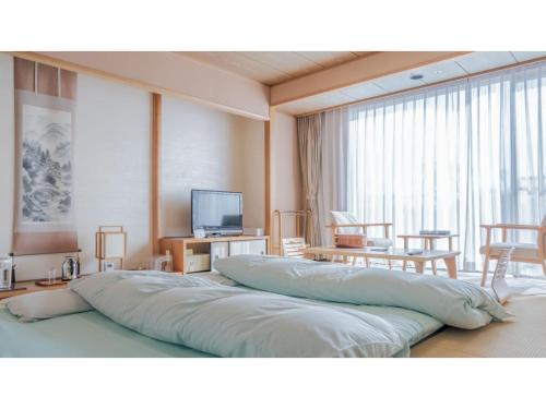 a large bed in a room with a large window at Ouka no sato La-Foret Shobara - Vacation STAY 35116v in Shōbara