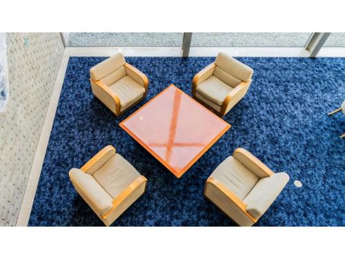 a group of chairs and a table on a blue carpet at Ouka no sato La-Foret Shobara - Vacation STAY 35116v in Shōbara