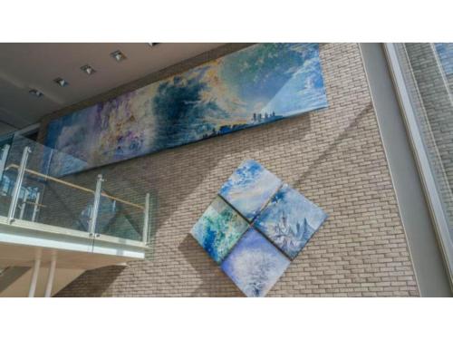 a wall with two paintings on the side of a building at Ouka no sato La-Foret Shobara - Vacation STAY 35116v in Shōbara