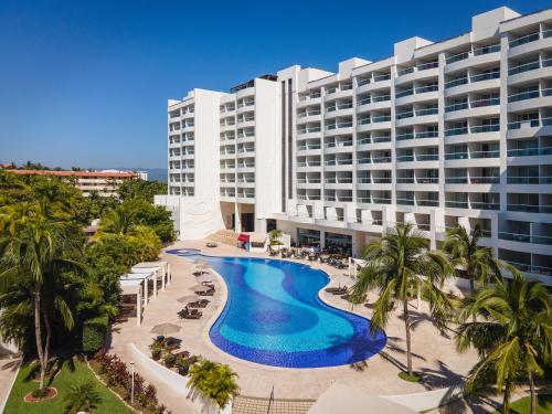 an aerial view of a hotel with a pool and palm trees at Fiesta Americana Riviera Nayarit Resort All Inclusive & Spa in Nuevo Vallarta
