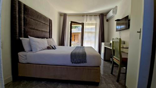 En eller flere senge i et værelse på 7 Heaven Boutique Hotel