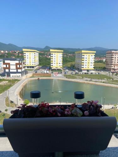 a flower pot in a window with a view of a pool at Lake View EIA in Lukavica