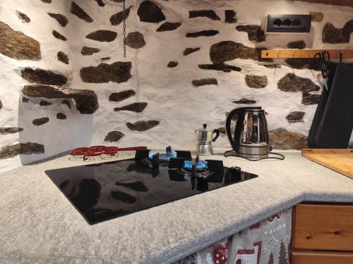 a kitchen counter top with a sink in a kitchen at Tipica casa di montagna nelle Valli di Lanzo in Groscavallo