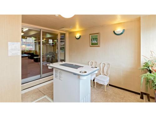 a lobby with two chairs and a counter in a room at Hotel New Ohte - Vacation STAY 32394v in Hakodate