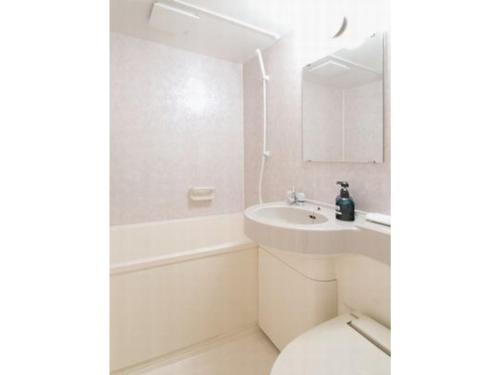 a white bathroom with a sink and a toilet at Hotel New Ohte - Vacation STAY 32396v in Hakodate