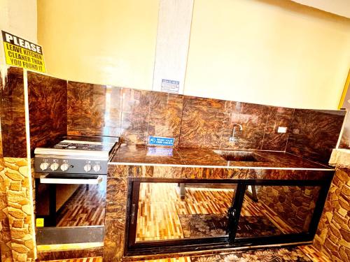 a kitchen with a counter and a sink and a stove at Julz Ridge Exclusive Place in Bayombong in Bayombong