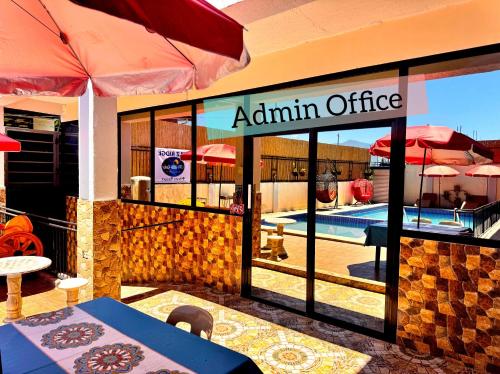a restaurant with an aquarium office with a table and umbrella at Julz Ridge Exclusive Place in Bayombong in Bayombong