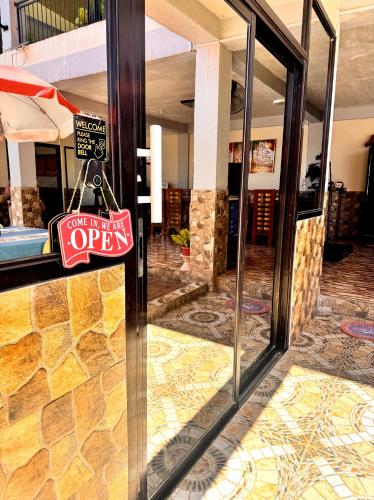 a sign on a glass door of a hotel at Julz Ridge Exclusive Place in Bayombong in Bayombong