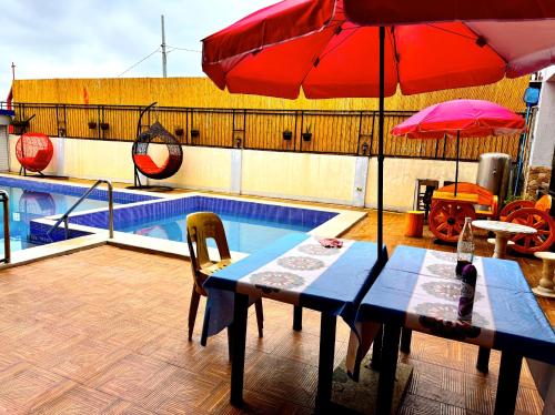 a table with an umbrella next to a swimming pool at Julz Ridge Exclusive Place in Bayombong in Bayombong