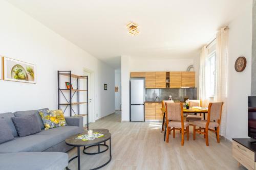 a living room with a couch and a table at Cozy Lagoon Apartment in Lezhë