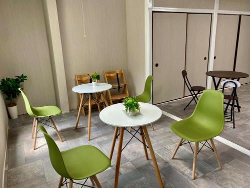 a room with two tables and green chairs at Matsukisou"children under 6 years old not allowed" - Vacation STAY 36205v in Beppu