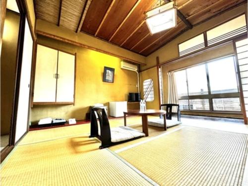 a living room with a table and some windows at Matsukisou"children under 6 years old not allowed" - Vacation STAY 36211v in Beppu