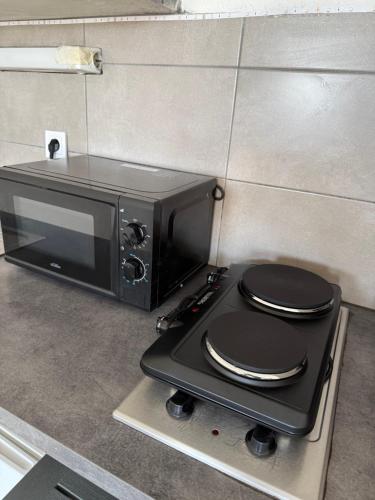 a microwave sitting on top of a counter with a toilet at Grand appartement Le Prado avec terrasse in Montpellier