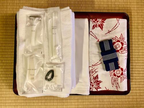 a suitcase with a tie and a watch and napkin at Matsukisou"children under 6 years old not allowed" - Vacation STAY 36196v in Beppu