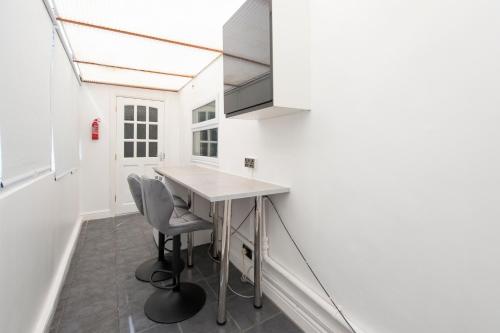 a kitchen with a table and two chairs at Luna Homes in Dartford