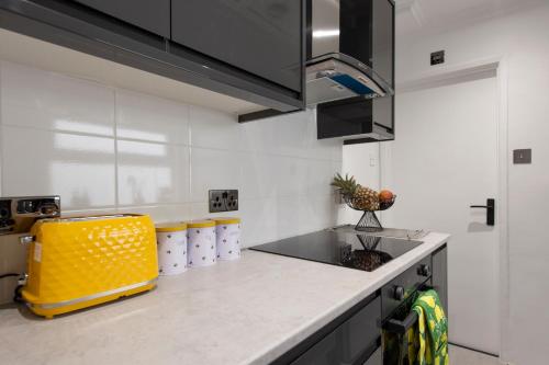 a kitchen with a counter with a yellow appliance at Luna Homes in Dartford