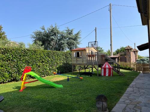 a backyard with a playground with a slide at Alloggio FELICE in Valmontone