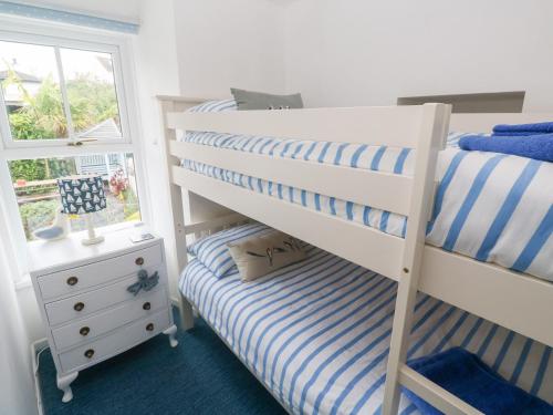 a bedroom with a bunk bed and a window at 2 The Cottages in Ludgvan