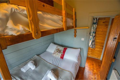 a bedroom with two bunk beds with white sheets at Red Robin Nest in Galway